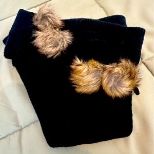 Black knitted legwarmers with faux fur tassels.